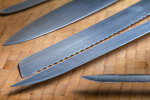 istock Many different iron knives tools on a wooden background 486900878