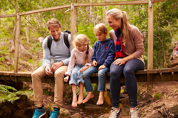 istock Happy family playing on a bridge in forest, full length 486900940