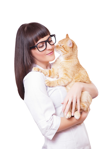 Portrait of a beautiful woman holding red cat, isolated on a white background