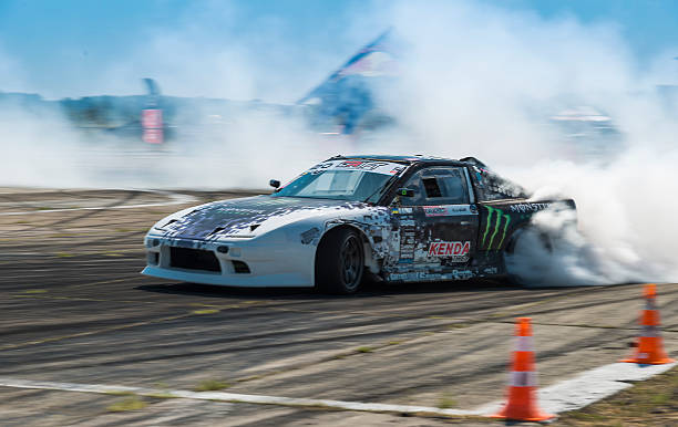 Rider Dmytro Illyuk  on the car brand Nissan  Vinnytsia,Ukraine-July 25, 2015: Rider  Dmytro Illyuk  on the car brand Nissan overcomes the track in the  Drift championship of Ukraine  on July 25,2015 in Vinnytsia, Ukraine. monster energy stock pictures, royalty-free photos & images