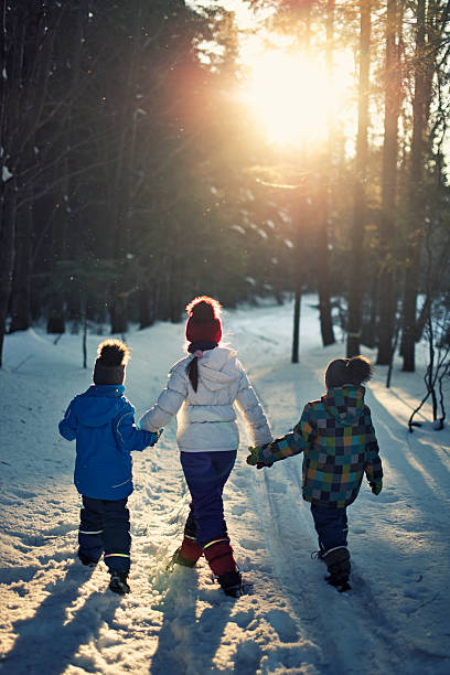 istock Kids walking in winter forest 486904214