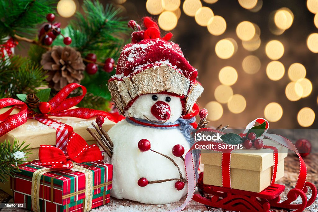 Christmas decoration Snowman and Christmas presents  over wooden background 2015 Stock Photo