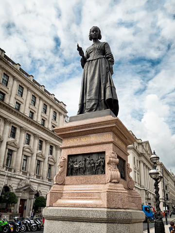 London, England - September 3, 2015: A memorial to and statue of Florence Nightingale, part of the The Guards Crimean War Memorial in Waterloo Place, Central London. Florence Nightingale is often known as ‘The Lady With the Lamp’: she worked incredibly hard to improve standards at Scutari Hospital in the Crimea and would walk the wards at night, with a lamp, talking to ill and dying men and writing letters for them.