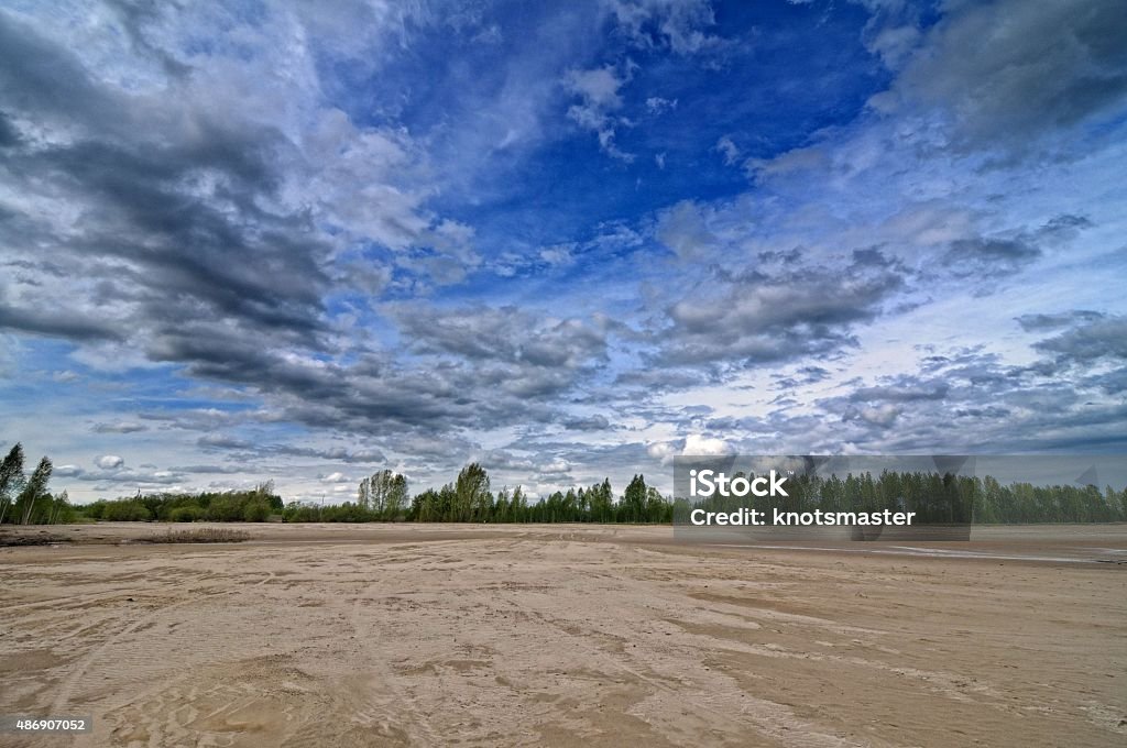 Sandy beach Sandy beach with bushes and cloudy sky 2015 Stock Photo