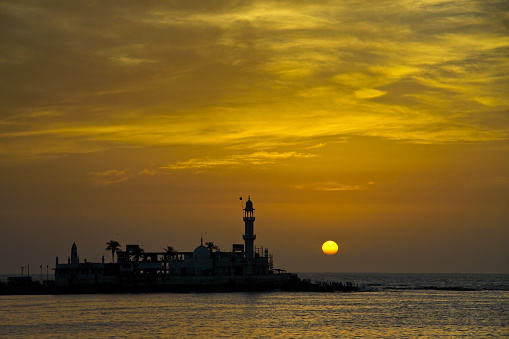 The Haji Ali Dargah is a mosque and dargah (tomb) located on an islet off the coast of Worli in the Southern part of Mumbai. Near the heart of the city proper, the dargah is one of the most recognisable landmarks of Mumbai. This is one of the attraction in Mumbai. Taken this picture at sunset during my visit to city of Mumbai.