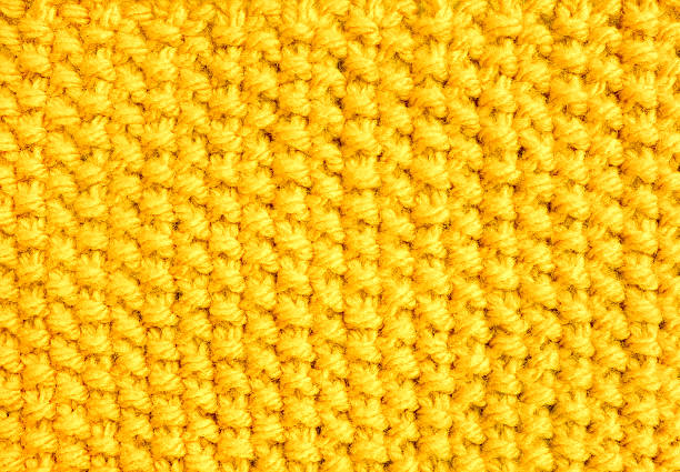 istock Knitting in moss stitch with yellow yarn 486909262