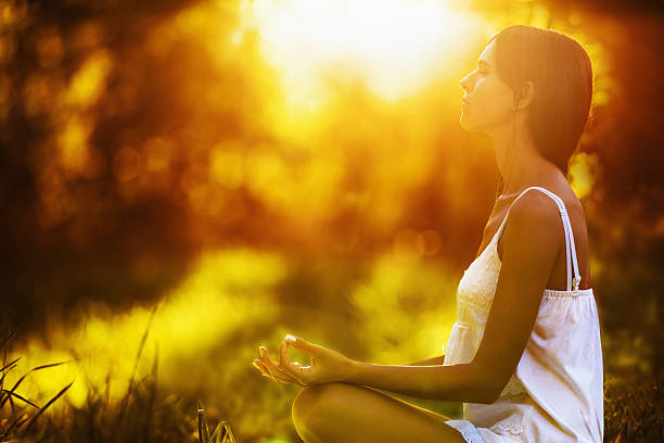 istock Yoga woman meditating at sunset 486909850