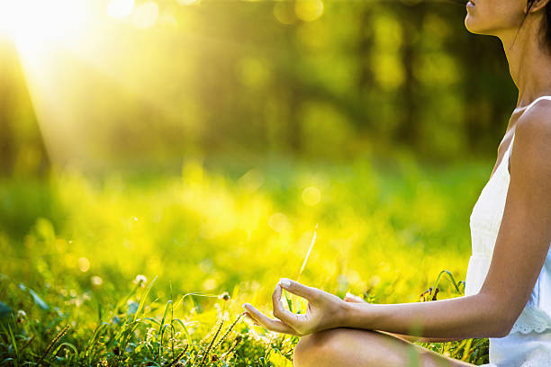 istock Yoga woman meditating at sunset 486909870