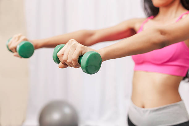 istock woman exercising at the gum 486910050