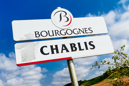 Chablis, France - July 30, 2014: Road sign for the famous wine village of Chablis in the Burgundy region of France. The small town of Chablis is noted for its very fine chardonnay wines.