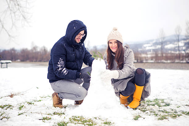 istock Cute Couple Making Snowman 486911594