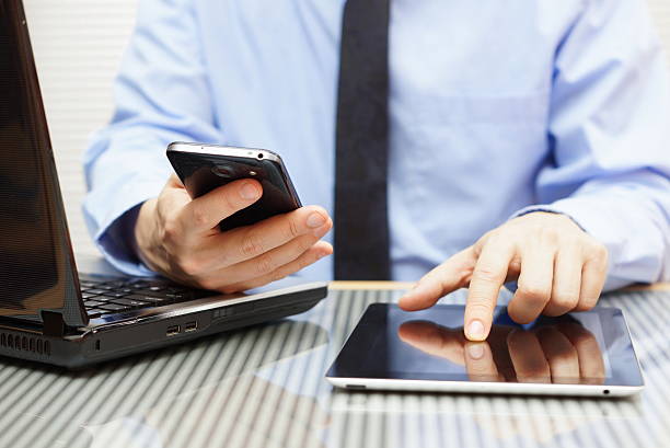 istock Businessman with tablet and smart phone 486912477