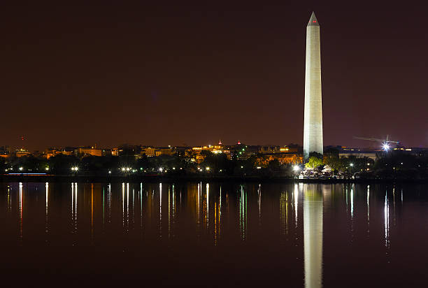 istock Washington Monument at night with city skyline on background. 486913149