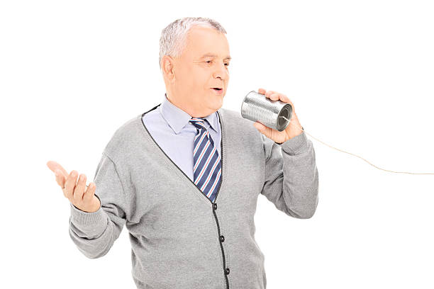 istock Senior man talking through a tin can phone 486914143