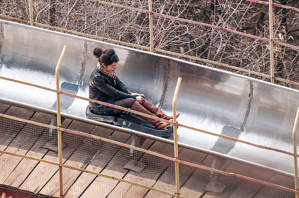 slide down from the great wall Beijing,China - March 30 ,2011 : Visitor use toboggan-run slide down in motion blur from the great wall of China at Mutianyu pass in Beijing,China.That is fast way and fun to come down. mutianyu toboggan stock pictures, royalty-free photos & images