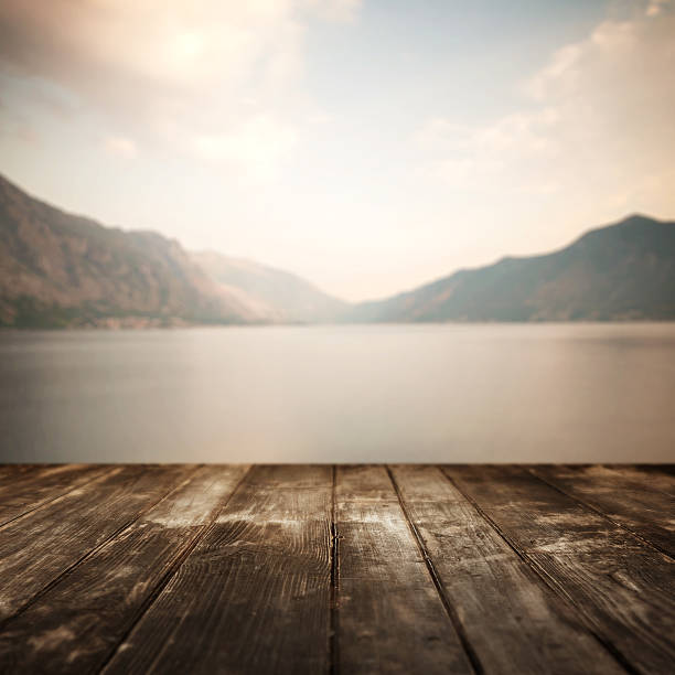 Wooden planks and defocused summer landscape on background