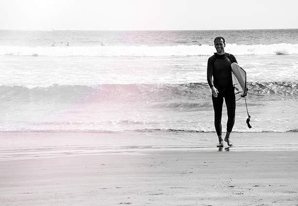 istock Young surfer on the beach, black and white 486914868
