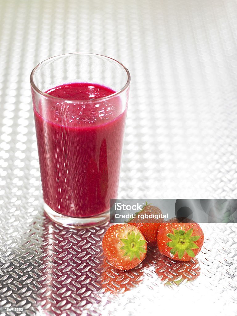 Beet Nik Smoothie A glass of Beet Nik smoothie with strawberries on an embossed metal surface Brocade Stock Photo