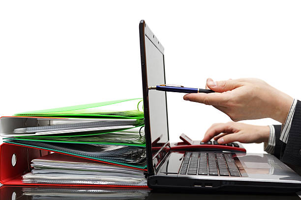 auditor pointing with pen on laptop screen, showing financial information auditor pointing with pen on laptop screen, showing financial information tabs ring binder office isolated stock pictures, royalty-free photos & images