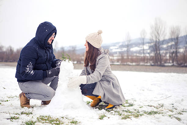 istock Cute Couple Making Snowman 486916138