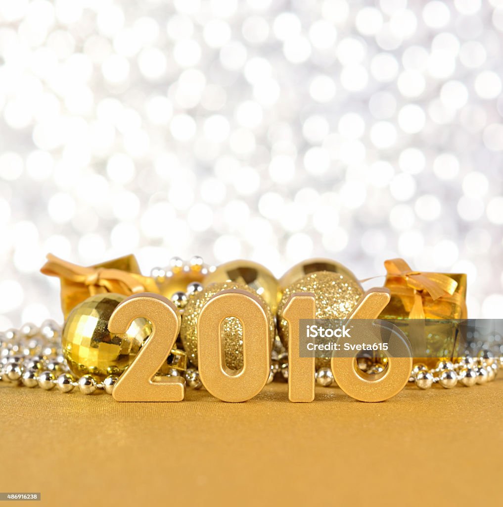 2016 year golden figures and Christmas decorations 2016 year golden figures on the background of Christmas decorations 2015 Stock Photo