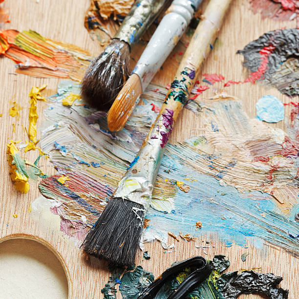 istock few paintbrushes on used artistic pallette 486919163