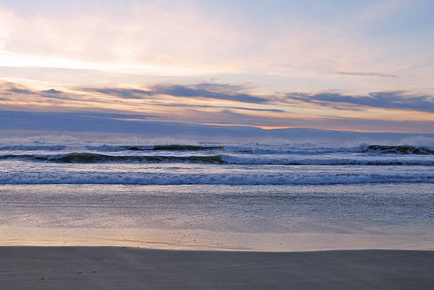Ocean Sunset Blue and Pink Clouds. Oregon Coast Sunset with great colors in the background. Calm Waters and low waves. 