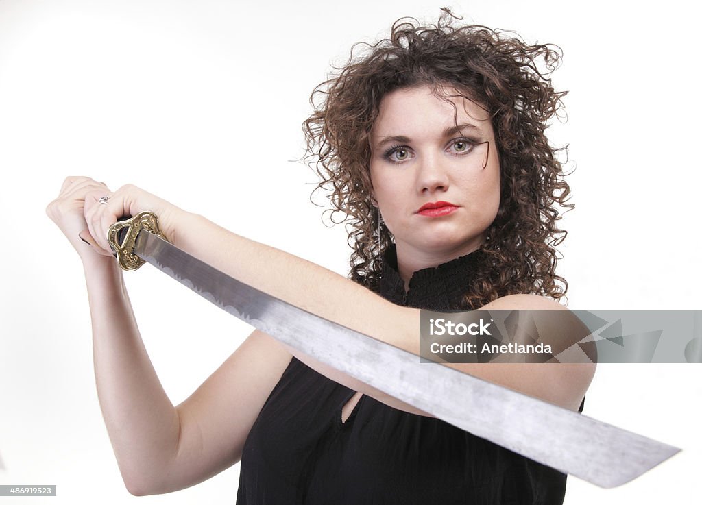 piercing woman curly girl and sword Girl - Ear super piercing woman dark hair natural brown-haired holding in her hands a katana Abstract Stock Photo