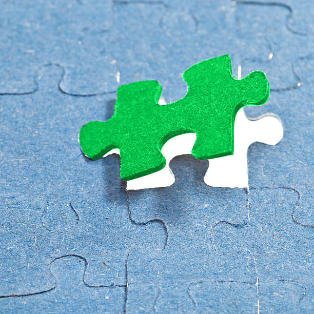istock setting the last green piece of puzzle 486919671