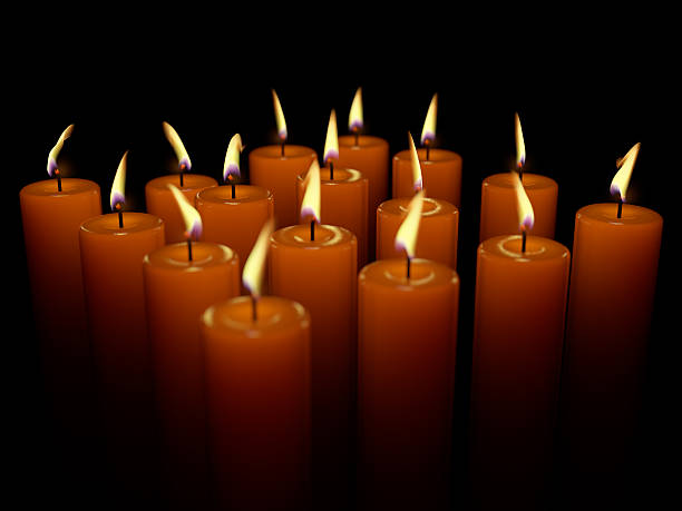 istock Closeup of burning many candle isolated on black background 486919789