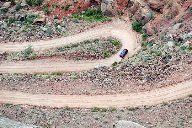 istock Red car on the road Long Canyon Rd,Moab,USA 486919958