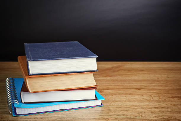 istock books on wooden deck table and grunge background 486919973