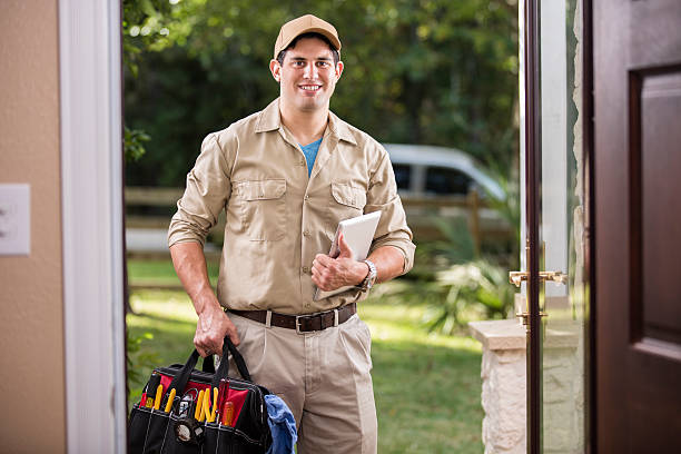 istock Service Industry: Latin descent repairman at customer's front door. 486920250