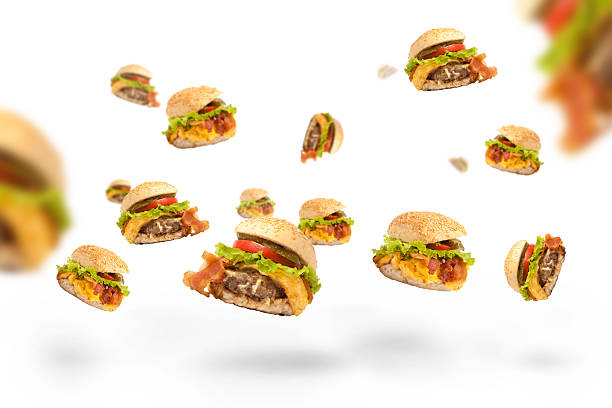 hamburger fallen - three dimensional hamburger unhealthy eating isolated on white stock-fotos und bilder
