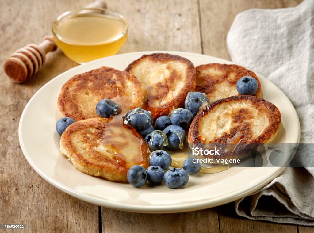 Pancakes with honey and blueberries Pancakes with honey and blueberries on wooden table 2015 Stock Photo