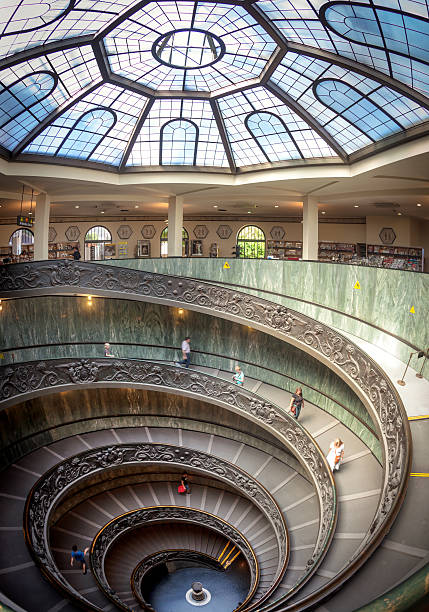 Rome, Italy - 11 September, 2010: The old stairway inside the Vatican museum with moving people in Rome, Italy