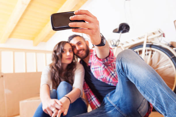 istock beautiful young couple take a selfie after moving 486922482