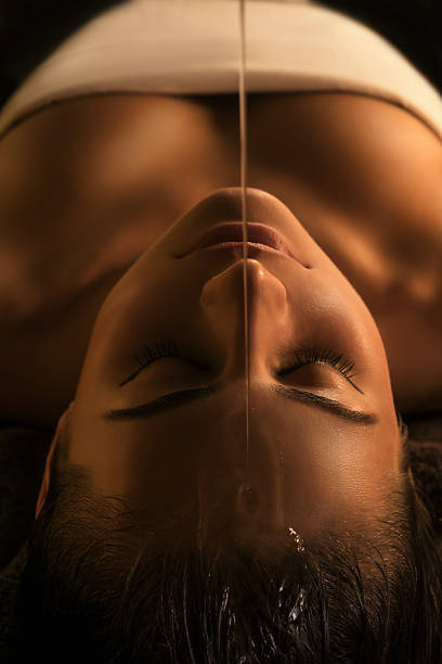 Shirodhara massage - close-up The girl has Shirodhara treatment - indian oil massage. ayurveda stock pictures, royalty-free photos & images