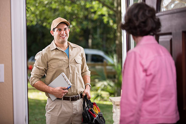 istock Service Industry: Latin descent repairman at customer's front door. 486923986