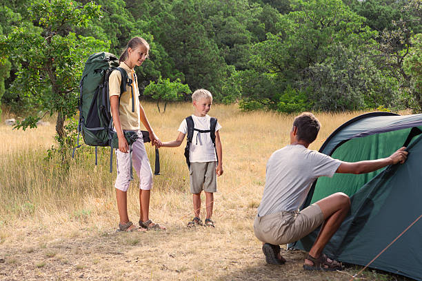 istock Father with children near tent 486924656