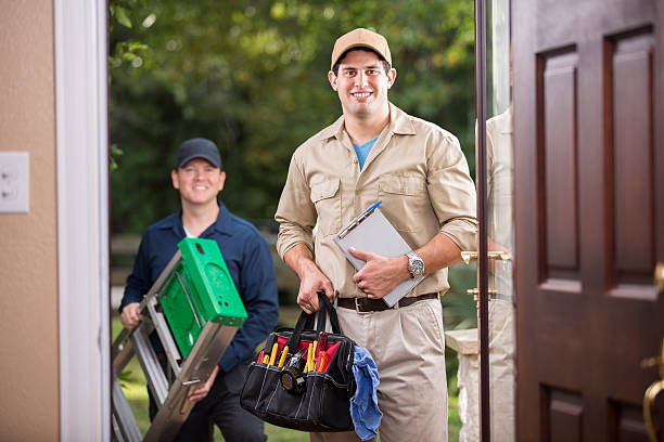 istock Service Industry: Two multi-ethnic repairmen at customer's front door. 486924818