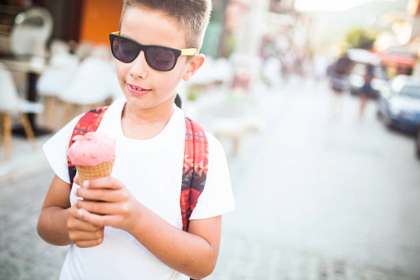 istock Boy in sunglasses eating popsicle 486925200