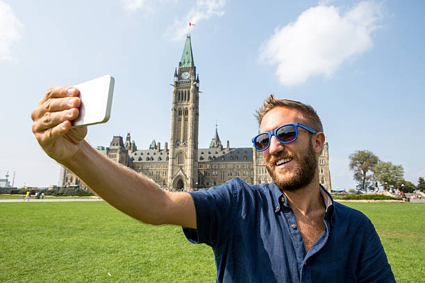 istock Young cheerful man in Ottawa-Canada taking a selfie portrait 486925650