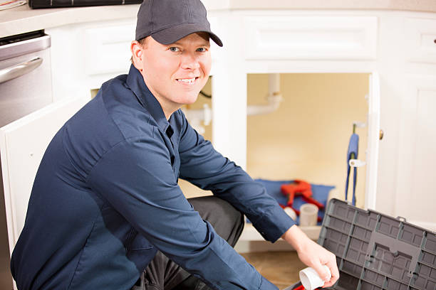 istock Plumber, repairman working under sink in home kitchen. 486925698