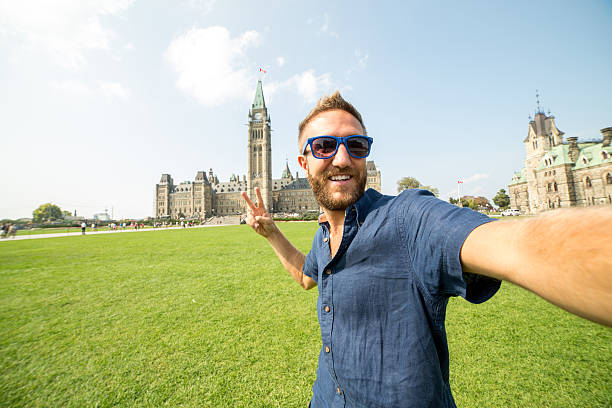 istock One man taking selfie portrait at Ottawa parliament 486925888