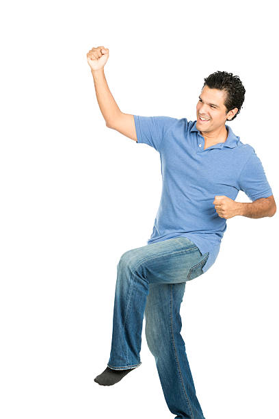 istock Fist Pumping Hispanic Male No Shoes Celebration 486927130