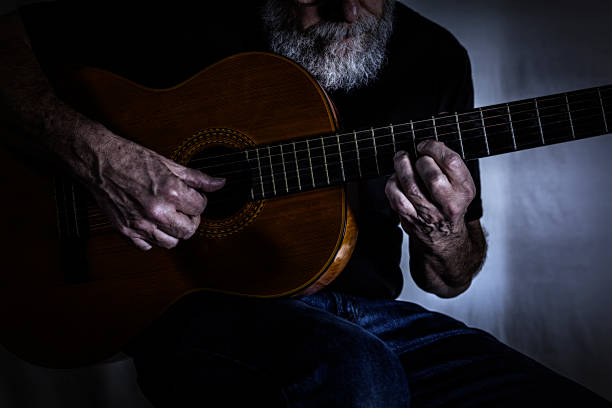 istock Dark Room Man Playing Acoustic Guitar 486929442