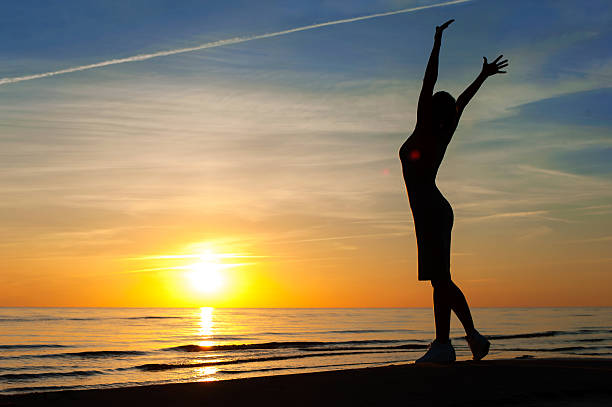 istock Enjoying the summer evening. Cheerful woman silhouette on sunset background. 486929672