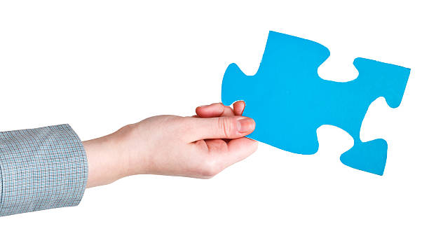 istock female hand holding big blue paper puzzle piece 486932845