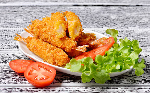 istock Fried shrimp on wooden background. 486933200